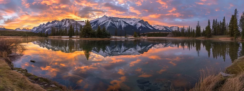 a majestic sunrise casts a golden glow over a serene mountain lake, reflecting the vibrant colours of the sky and the surrounding snow-capped peaks.