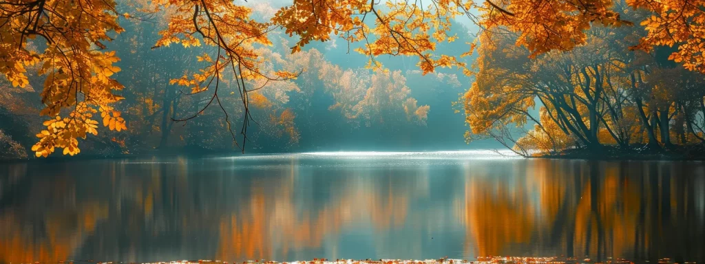 a vibrant autumn landscape displays a golden canopy of leaves framed by a tranquil lake, reflecting the rich hues of the season under soft, diffused sunlight.