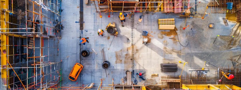 a vibrant urban construction site in cardiff showcases a diverse group of professionals engaged in advanced building techniques and digital technology, highlighting the future of the industry's skilled workforce.
